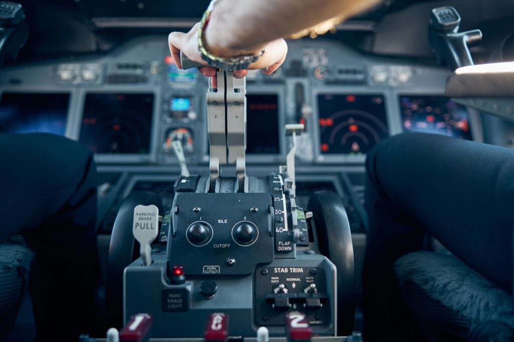 Captain hand accelerating on the throttle in commercial airplane