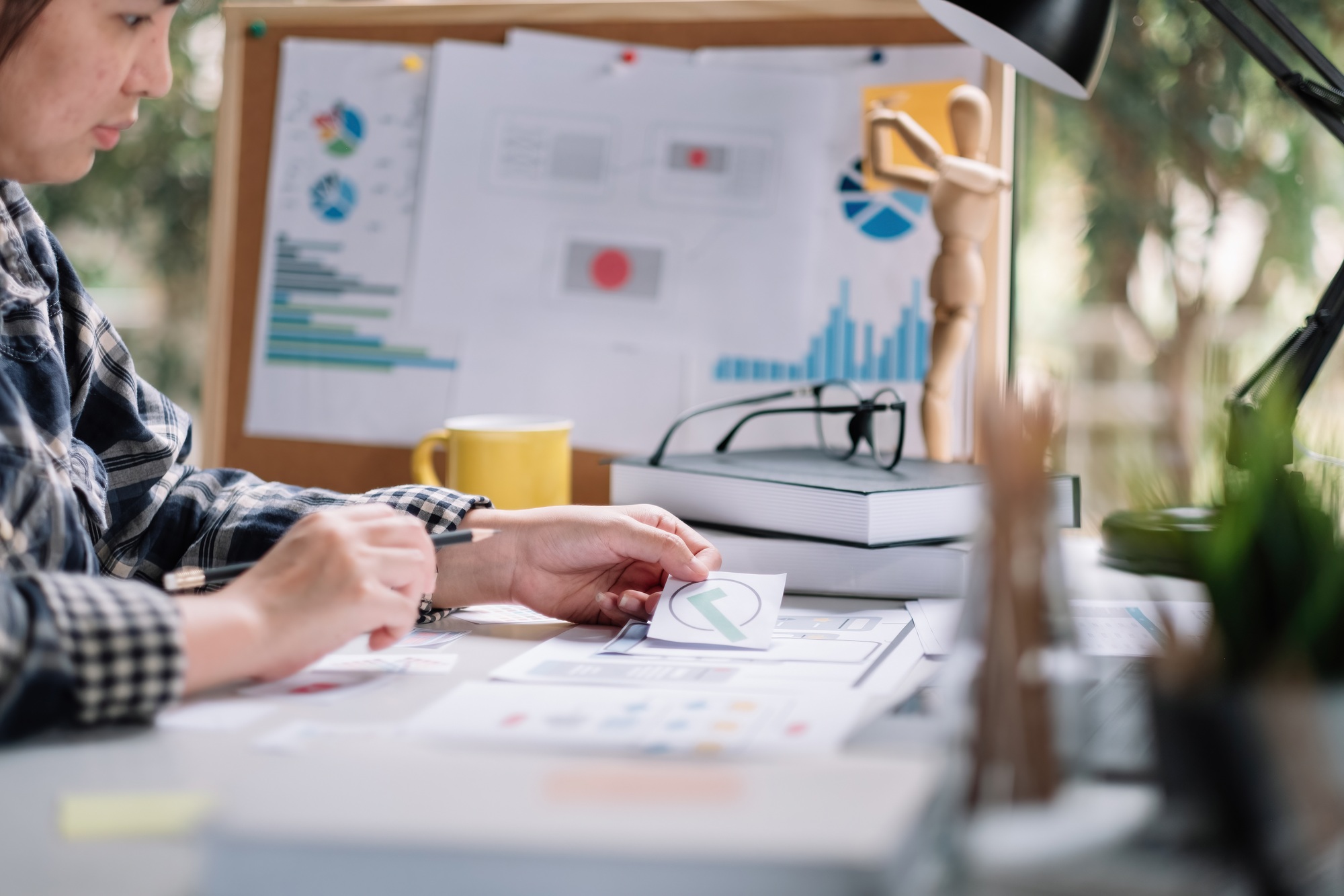 Close up App developer Ux Ui designing with paper model on mobile application prepare